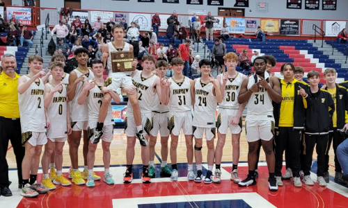 Men's basketball players on the court holding district trophy